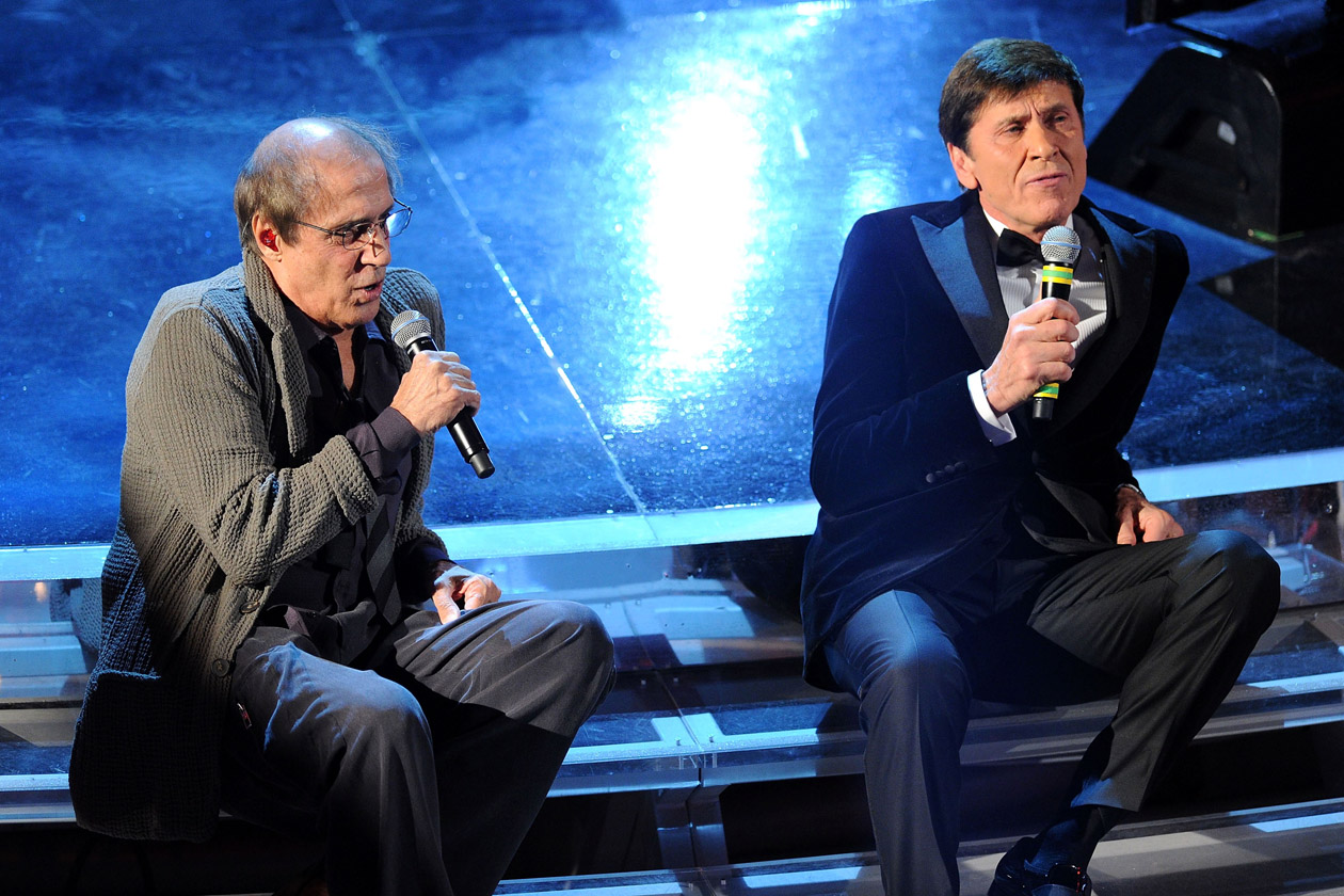 SANREMO, ITALY - FEBRUARY 18:  Gianni Morandi and Adriano Celentano performs on stage at the closing night of the 62th Sanremo Song Festival at the Ariston Theatre on February 18, 2012 in Sanremo, Italy.  (Photo by Daniele Venturelli/Getty Images)