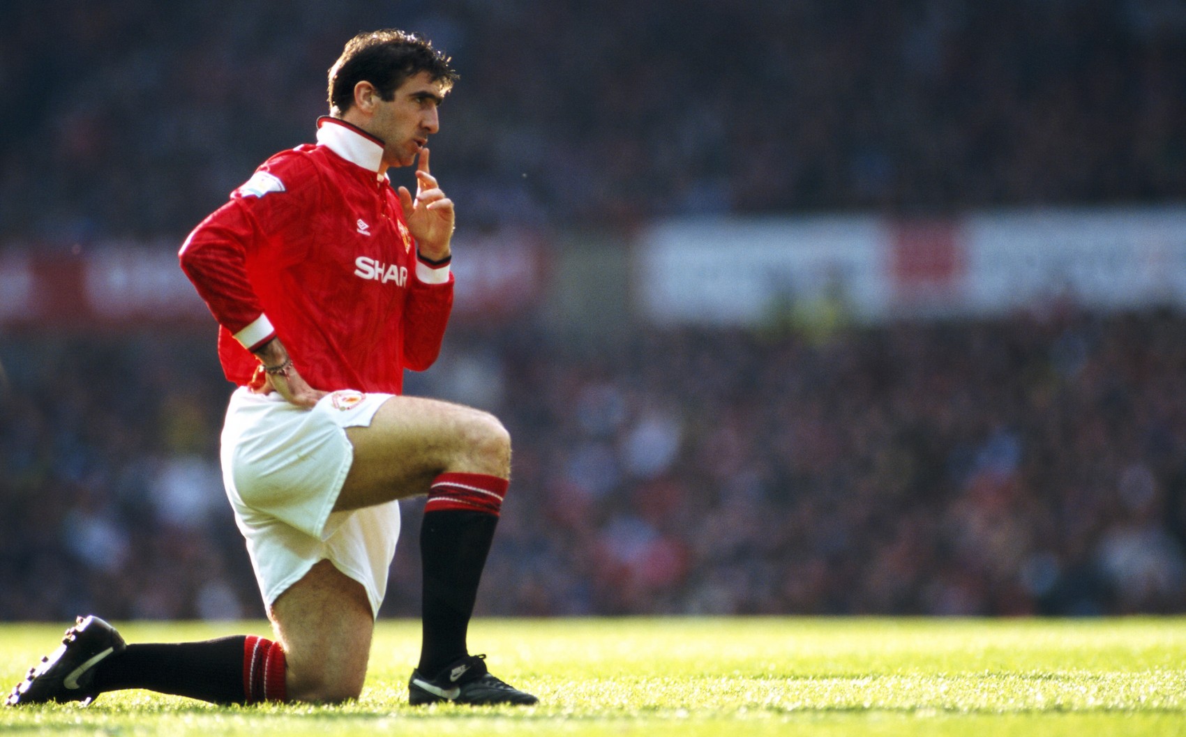 MANCHESTER, UNITED KINGDOM - APRIL 23: Manchester United striker Eric Cantona reacts during an FA Premier League match between Manchester United and Manchester City at Old Trafford on April 23, 1993 in Manchester, England, United won the game 2-0 with both goals scored by Cantona.  (Photo by Anton Want/Allsport/Getty Images)
