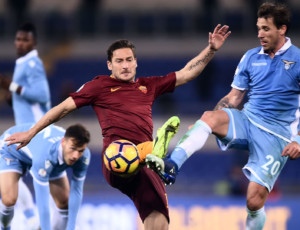 Roma's forward from Italy Francesco Totti (C) vies with Lazio's midfielder from Argentina Lucas Biglia during the Italian TIM Cup 1st leg semifinal football match on March 1, 2017 at the Olympic stadium in Rome.  / AFP PHOTO / FILIPPO MONTEFORTE        (Photo credit should read FILIPPO MONTEFORTE/AFP/Getty Images)